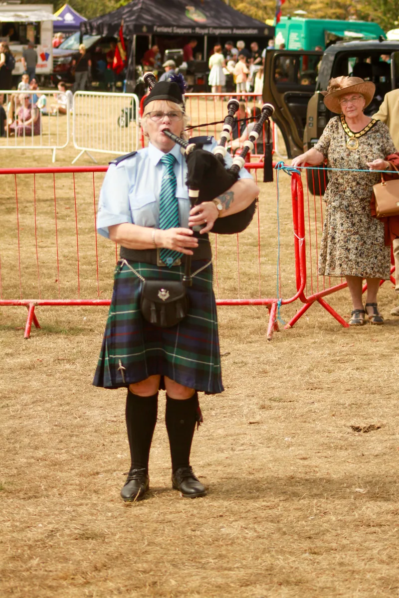 A Bomber County piper playing at an outdoor show